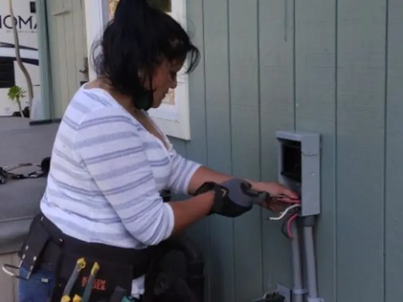 Licensed electrician wiring an exterior subpanel in Mobile